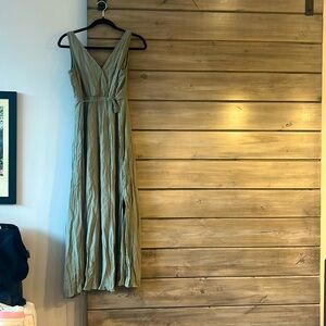 Long green dress with a small slit.